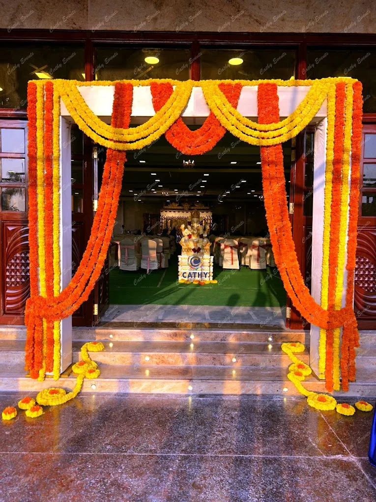 Entrance framed with marigold garlands and drapes