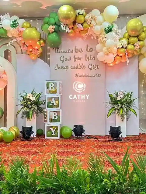 Baby shower stage with pastel balloon garlands, arches and baby blocks
