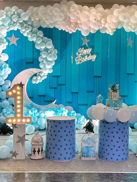 Blue moon and stars first birthday backdrop with a marquee number one